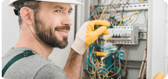 electrician working on a residential circuit breaker panel