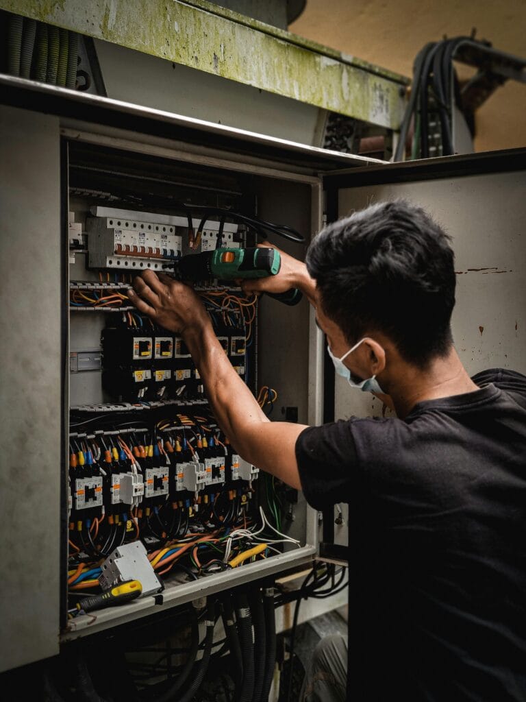 residential electrician working on an electrical panel